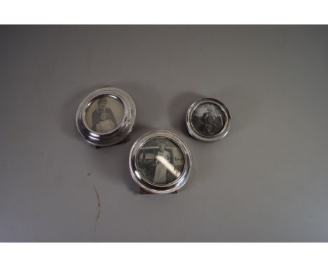 THREE SMALL SILVER MOUNTED CIRCULAR EASEL BACK PHOTO FRAMES