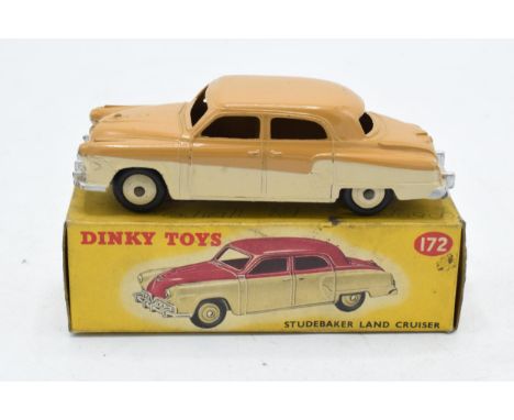 A Dinky Studebaker land cruiser No. 172 having a cream lower body and light tan upper body with cream hubs, displayed in its 