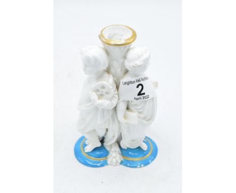 Late 19th century Continental porcelain candlestick or similar item depicting cherubs wearing robes (a/f). 15cm tall. Chippin