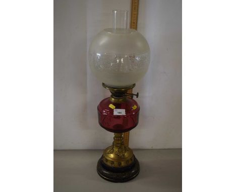 Oil lamp with cranberry tinted font and frosted glass shade