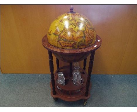 A drinks cabinet in the form of a terrestrial globe with decanter and glassware, approximately 90 cm (h)