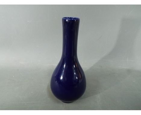 A Chinese deep blue glaze, monochrome, bottle vase Kangxi double circle, six character mark to the base. Approximately 20 cm 