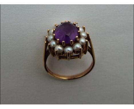 A lady's hallmarked 9 carat gold dress ring, set with an Amethyst stone surrounded by twelve cultured pearls , size N, approx