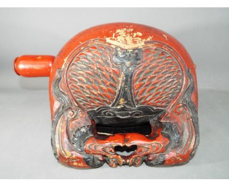 A carved and lacquered monastery bell (mokugyo) and beater, the handle formed by two confronting dragon heads, their manes tr