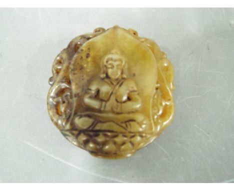 A small Chinese Tibetan russet jade carving depicting a seated Buddha with twin carved phoenix verso, approximately 5 cm (d)