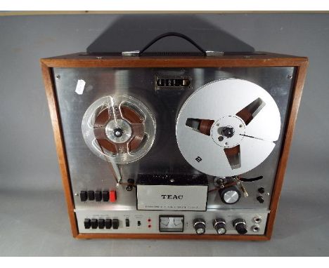 A vintage TEAC A-1500-W reel to reel recorder.