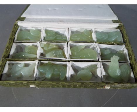 A set of twelve carved celadon jade (dragon is white jade) Chinese zodiac figures, boxed.