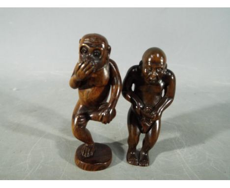 A vintage dark wood Japanese erotic Netsuke depicting an Oriental gentleman, signed and a vintage dark wood Japanese Netsuke 