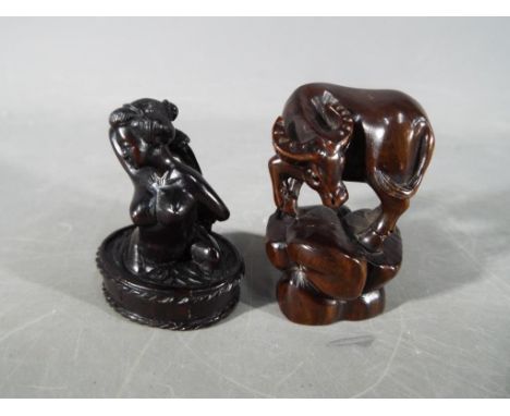 A vintage Japanese dark wood Netsuke depicting a lady bathing, signed and a vintage dark wood Japanese Netsuke depicting a ho