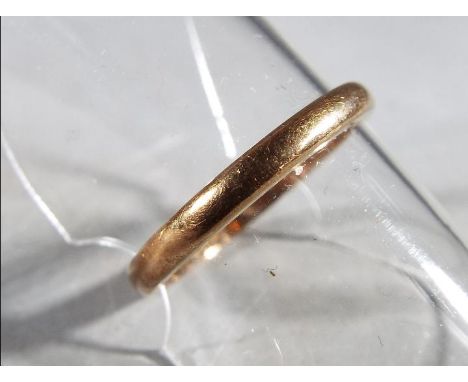 A 22ct gold wedding band, size K 1/2, approximately 2.75 grams total weight.