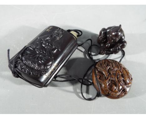 Netsuke - a vintage lacquered Japanese Inro and Netsuke depicting an Oriental person; the netsuke depicts a mythical dragon t
