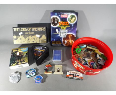 A mixed lot to include a quantity of novelty fridge magnets, The Lord of the Rings boxed set of thirteen cassettes, The Hobbi