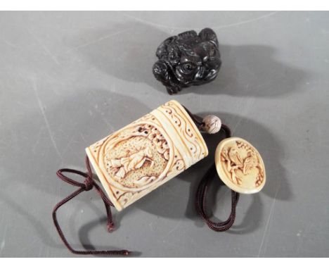 A vintage Japanese bone Inro and button Netsuke depicting an oriental gentleman on both sides of the Inro and two birds on th
