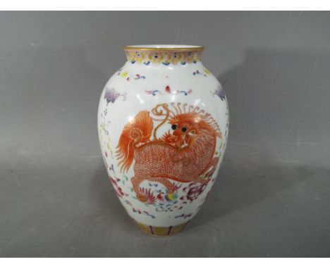 A rare Chinese fine porcelain vase, ruyi border to the rim, decorated with qilin and stylised flowers and enamelled eyes, iro