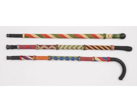 Ray Tucknott, two multicoloured ropework walking canes and a walking stick:. (3) 