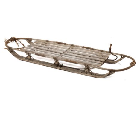 An early 20th century 'Nansen' pattern arctic sledge:, unsigned, over painted in grey, ash bentwood frame with pallet deck ra
