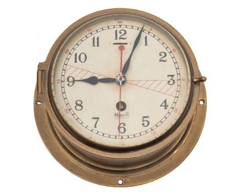 A brass cased radio room bulkhead clock by Mercer:,  the single barrel movement numbered 010064 to backplate, white enamel di