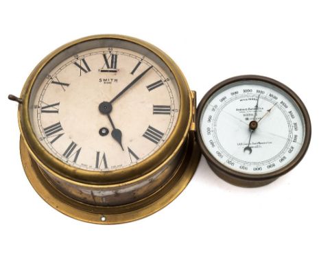 A brass  eight day bulkhead clock by Smiths, London:, white enamel dial with Roman numerals, signed as per title, under a hin