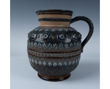 A large blue and brown round pitcher decorated with high relief art of flowers and leaf like patterns in varying shades of bl