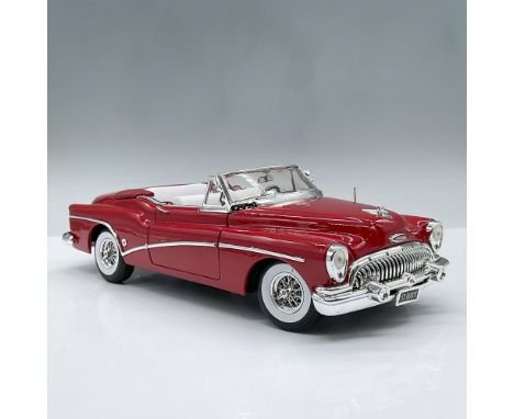 Sleek red model car with white and red interior, designed at a one eighteenth scale ratio. Movable parts include two doors, t