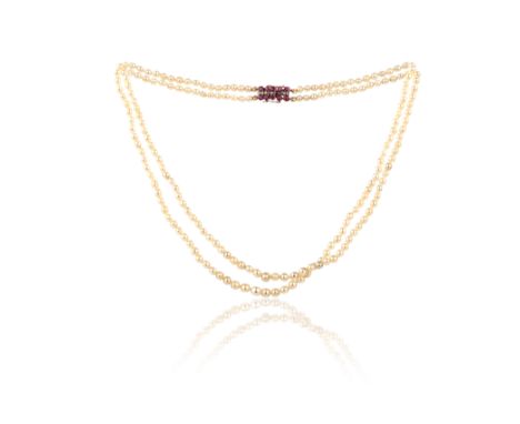 A natural pearl, ruby and diamond necklace, composed of a double strand of natural pearls measuring 3.2-5.1mm, to a clasp set
