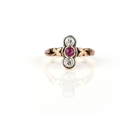 A ruby and diamond ring, early 20th century, set with a circular-cut ruby between circular-cut diamonds, to a gold foliate sh