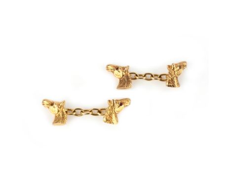 A pair of gold cufflinks, each end modelled as a horse's head, one eye accented with a ruby, to chain connections, length of 