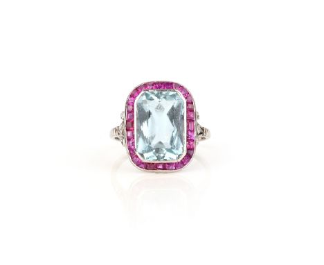 An aquamarine, ruby and diamond ring, set with a scissor-cut aquamarine, within a border of calibré-cut rubies, to fleur-de-l