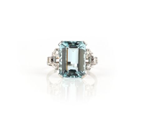 An aquamarine and diamond ring, claw-set with a step-cut aquamarine, to geometric shoulders set with single-cut diamonds, mou