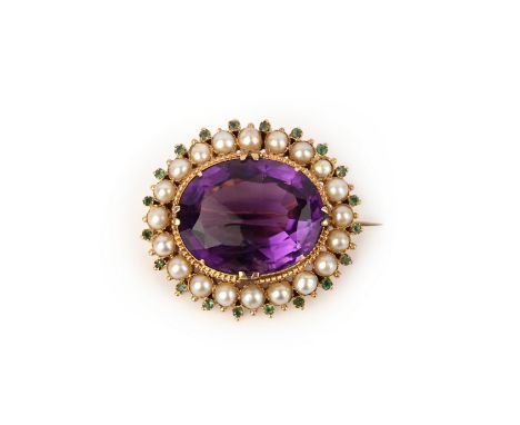 An amethyst, emerald and pearl brooch, mid 19th century, claw-set with an oval amethyst, within a border of half pearls accen