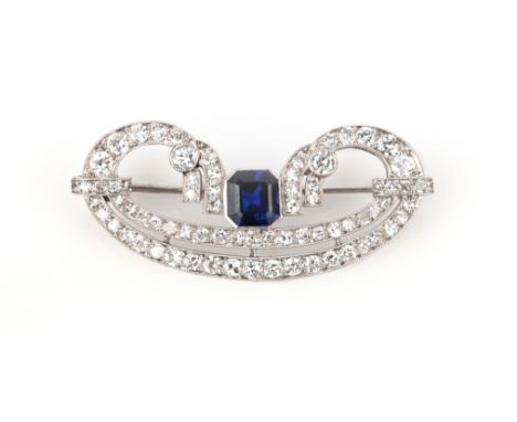 An Art Deco sapphire and diamond brooch, circa 1920, of ribbon design, set with single-cut diamonds and a step-cut sapphire, 