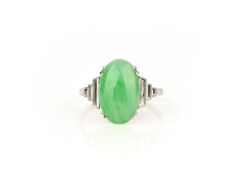 A jade-set platinum ring, the oval jade cabochon claw-set in platinum, size M