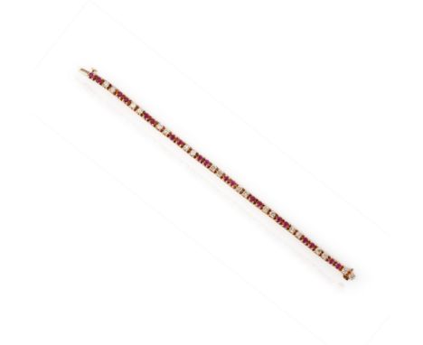 A ruby and diamond line bracelet, composed of articulated gold links set with circular-cut rubies and brilliant-cut diamonds,