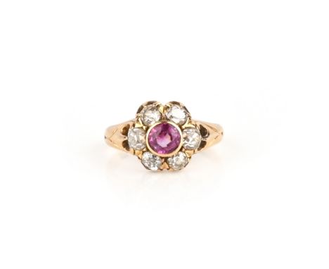 A late 19th century ruby and diamond cluster ring, the cushion-shaped ruby is set within a surround of old cushion-shaped dia