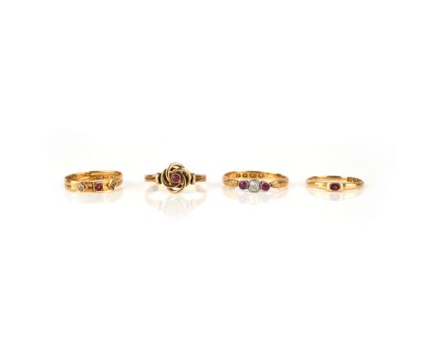 A group of four ruby rings, late19th/early 20th century, comprising: a 22ct gold ring set with a circular-cut ruby between tw