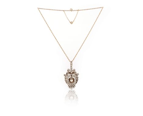 A late Victorian pearl and diamond pendant, the central pearl in a stylised shell suspending from a diamond surround and diam