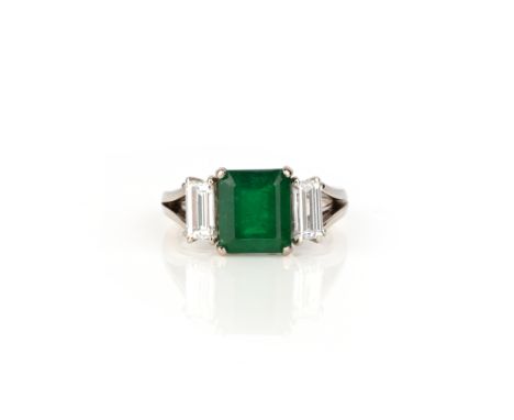 An emerald and diamond ring, claw-set with a step-cut emerald weighing 2.06 carats, to shoulders set with baguette diamonds, 