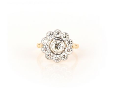 A diamond ring, of cluster design, set with brilliant-cut diamonds, mounted in yellow and white gold, size P1/2
