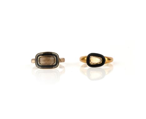 Two gold mourning rings, one set with black enamel surrounding a glazed locket compartment, size L, the other set with a toot