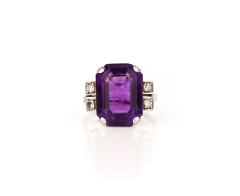 An amethyst and diamond ring, claw-set with a step-cut amethyst, to shoulders set with circular-cut diamonds, mounted in plat