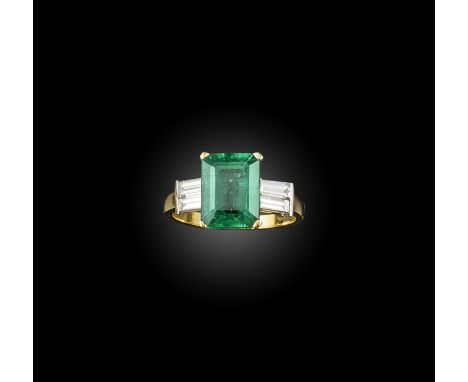 An emerald and diamond ring, claw-set with a step-cut emerald weighing 4.83 carats, to shoulders set with baguette diamonds, 