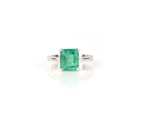 An emerald ring, claw-set with a step-cut emerald, size N1/2, stamped 750 and 18K