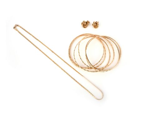 A group of gold jewellery, comprising: five patterned bangles, each stamped 18K; a plain 9ct gold bangle, British hallmark; a