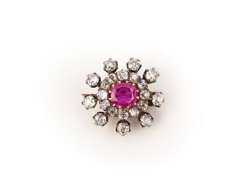 A ruby and diamond brooch, late 19th century, designed as a radiating cluster, set with cushion-shaped diamonds and centring 