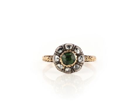 An emerald and diamond ring, late 18th Century, designed as a cluster, set with a step-cut emerald within a border of rose-cu