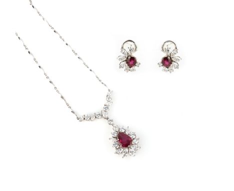 A ruby and diamond demi parure, comprising a pendant and earrings, the pendant set with a pear-shaped ruby within a border of