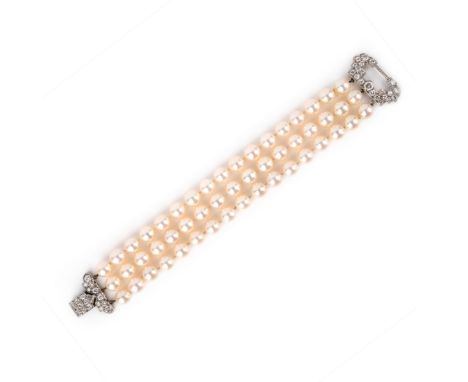 A cultured pearl and diamond bracelet, mid 20th century, composed of three rows of cultured pearls, to a clasp designed in th