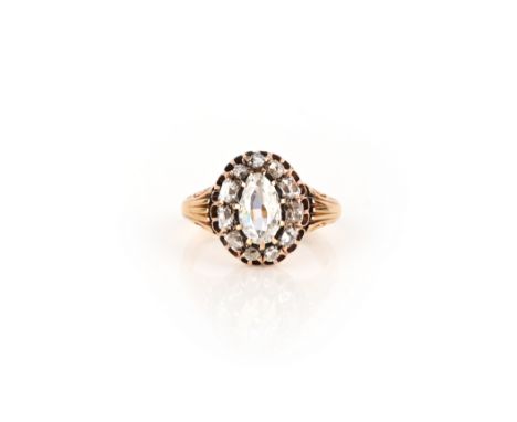 A diamond ring, 19th century, designed as a cluster, set with an elongated pear-shaped diamond within a border cushion-shaped