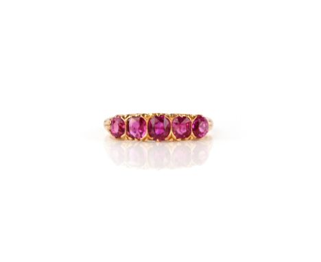 A ruby five-stone ring, late 19th century, set with a series of five graduated cushion-shaped rubies, to a gold shank with sc