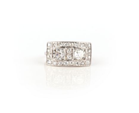 An Art Deco diamond ring, 1930s, the front designed as a curved plaque set with two cushion-shaped diamonds within square set